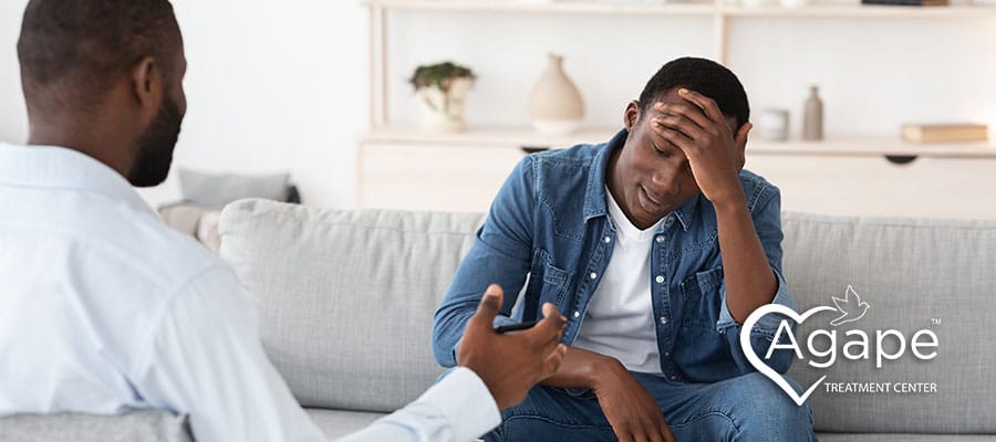 man sitting with his therapist during cognitive behavioral therapy session